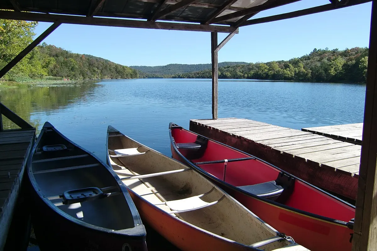 Canoes beside a wooden dock on Lake Leatherwood in Eureka Springs, Arkansas